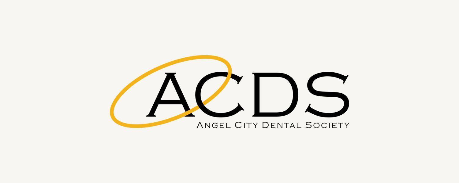 The logo for the angel city dental society is black and yellow.