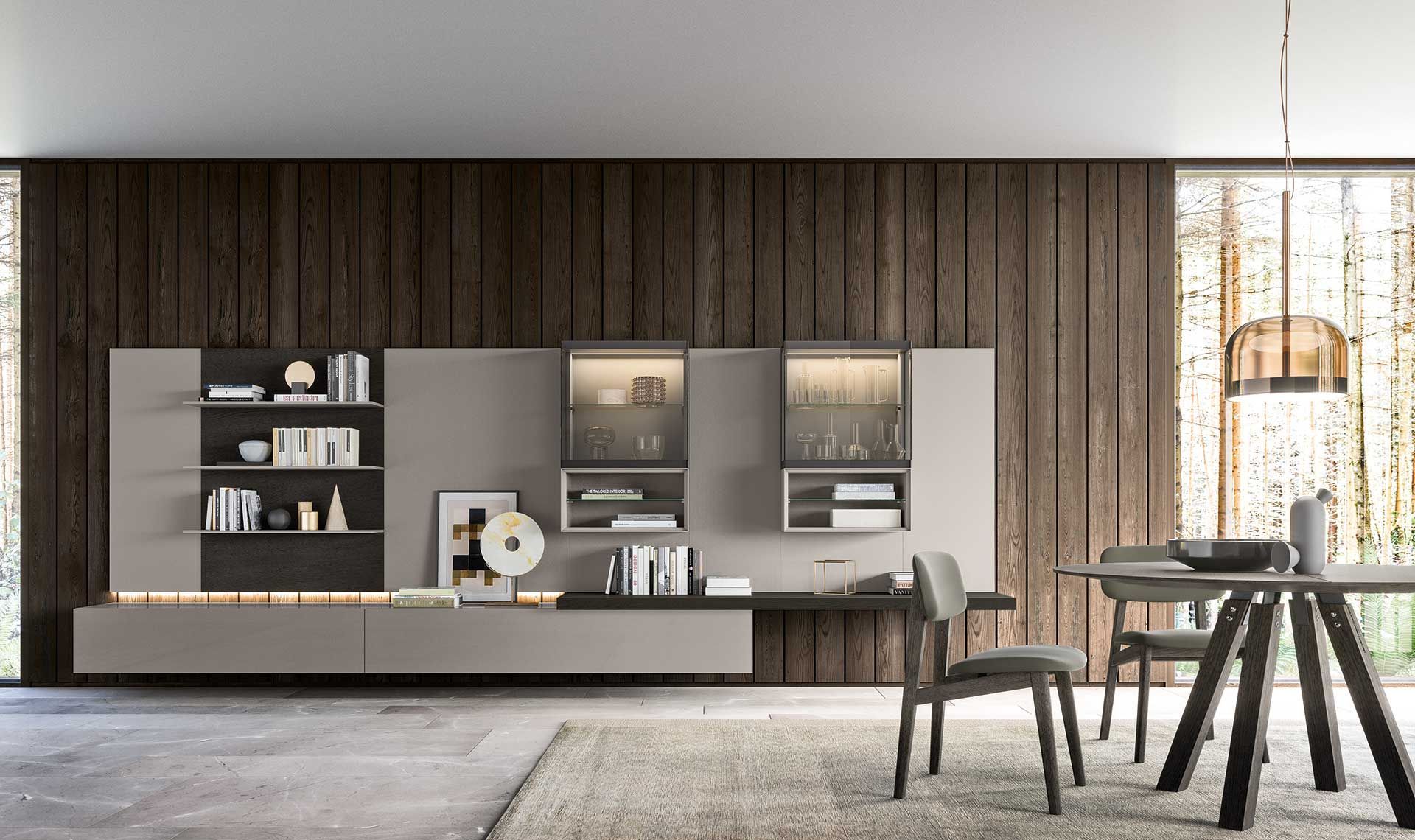 Soggiorno moderno con parete attrezzata grigia e in legno, tavolo, sedie e tappeto.
