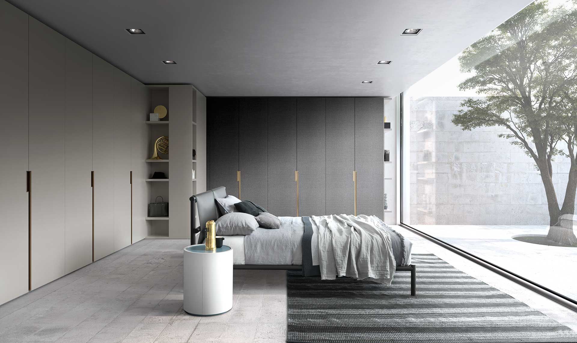 Camera da letto moderna con letto, armadio e ampia finestra con vista su un albero.