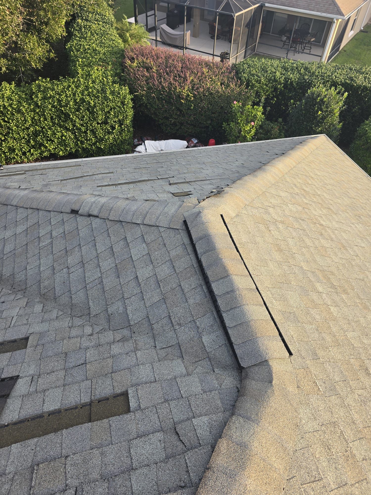 Logams Roofing technician repairing roof damage on a Kissimmee home, restoring hurricane-rated protection and preventing water intrusion.