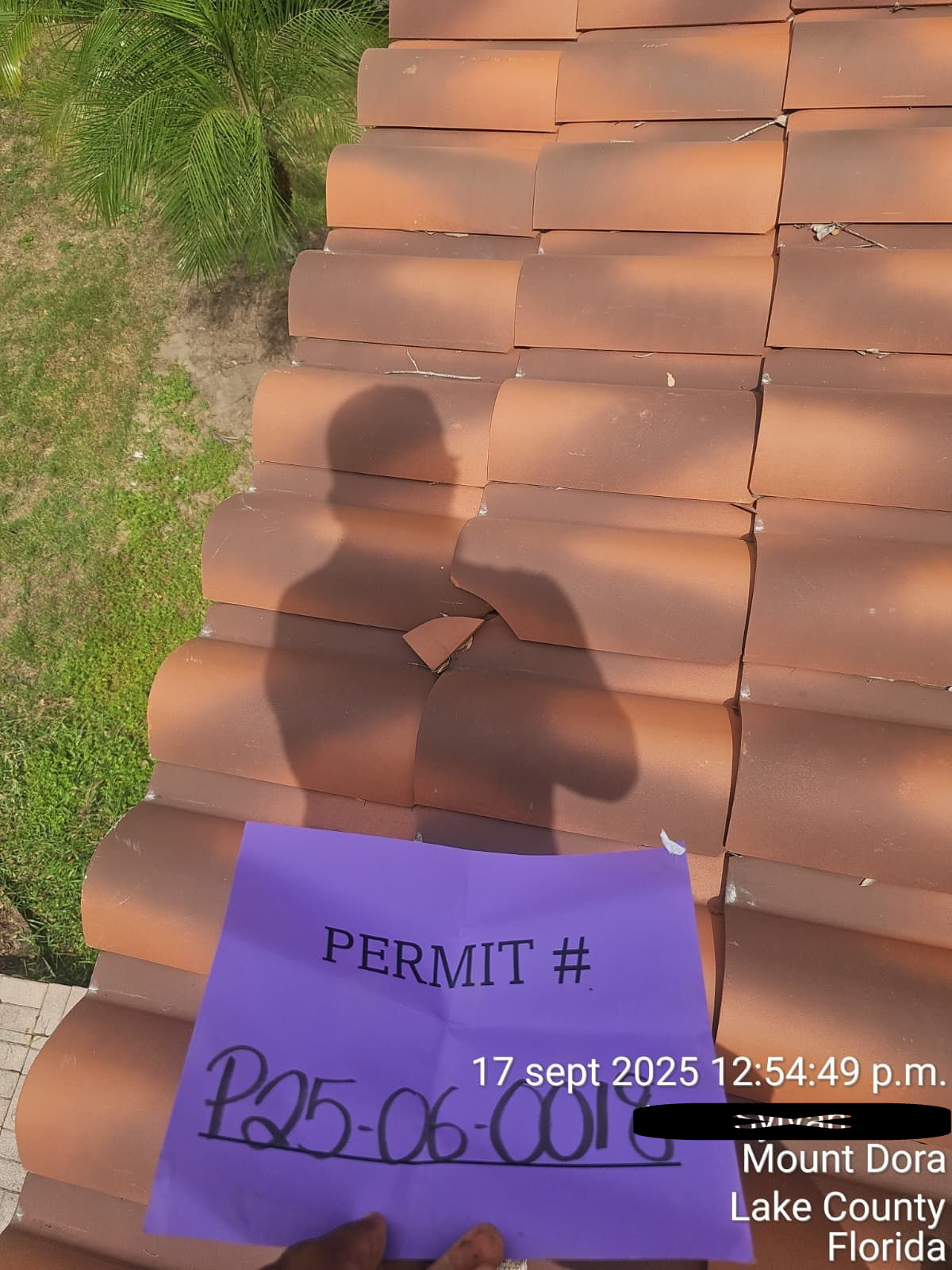 Close-up of damaged clay tile roof in Mount Dora FL showing cracked tiles before roof replacement service.