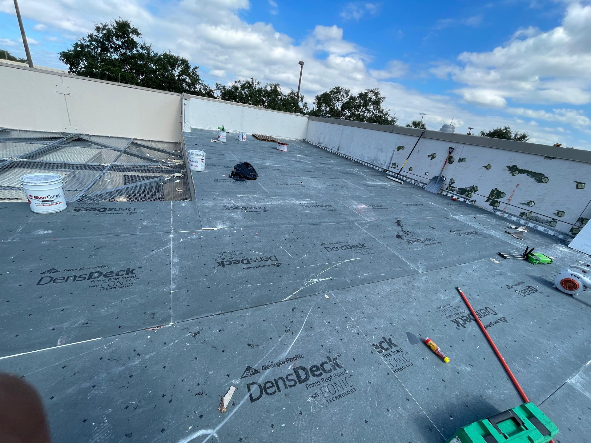 Flat roof replacement in Orlando FL using DensDeck and modified bitumen materials for durable waterproof protection.