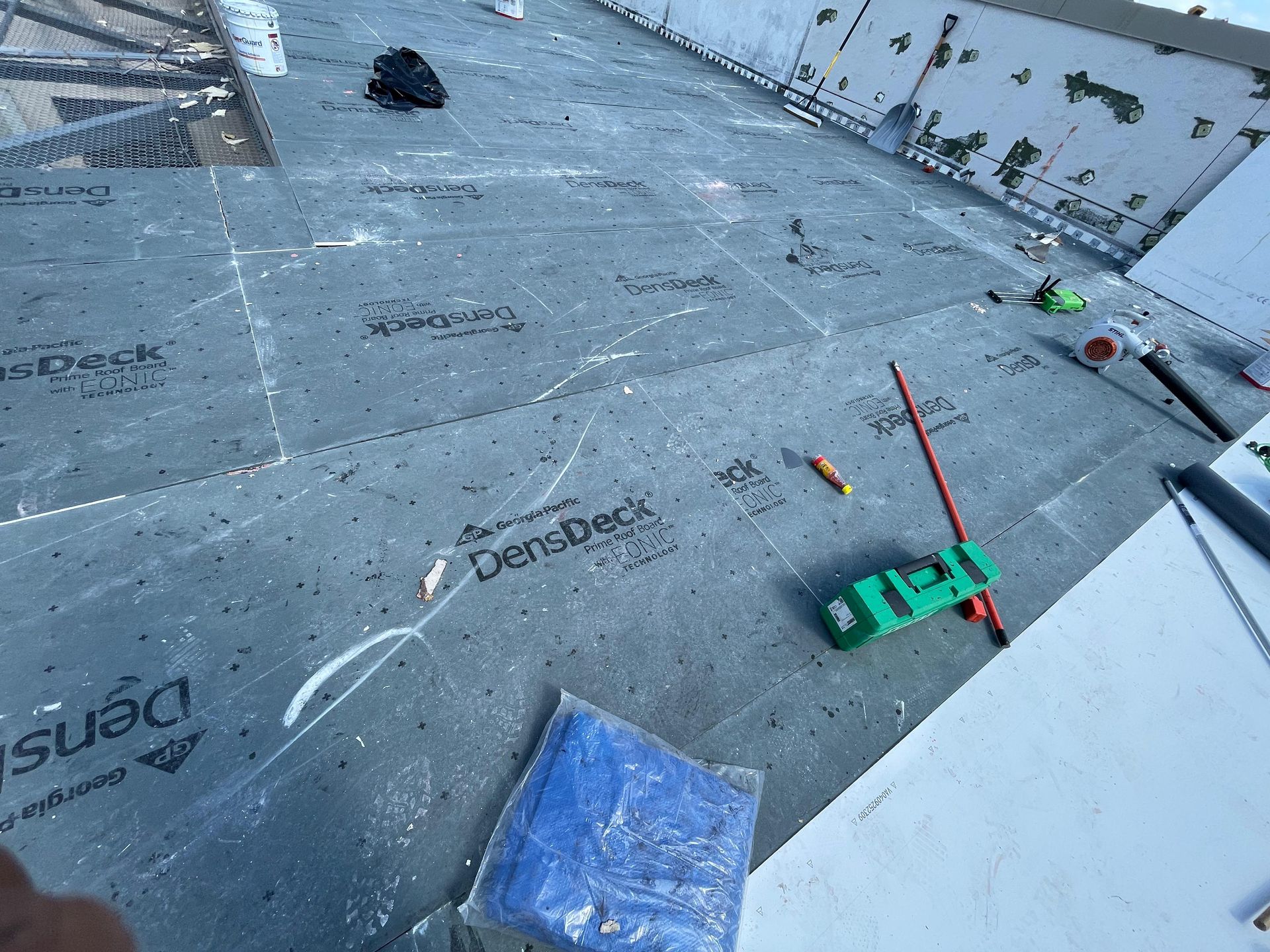 Professional flat roof installation in Central Florida — preparing underlayment and insulation for long-lasting commercial roofing system.