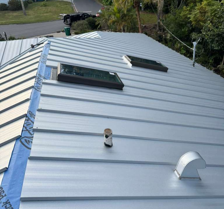 Shingle roof replacement in Florida with synthetic underlayment installation — preparing damaged roof deck for new asphalt shingles.