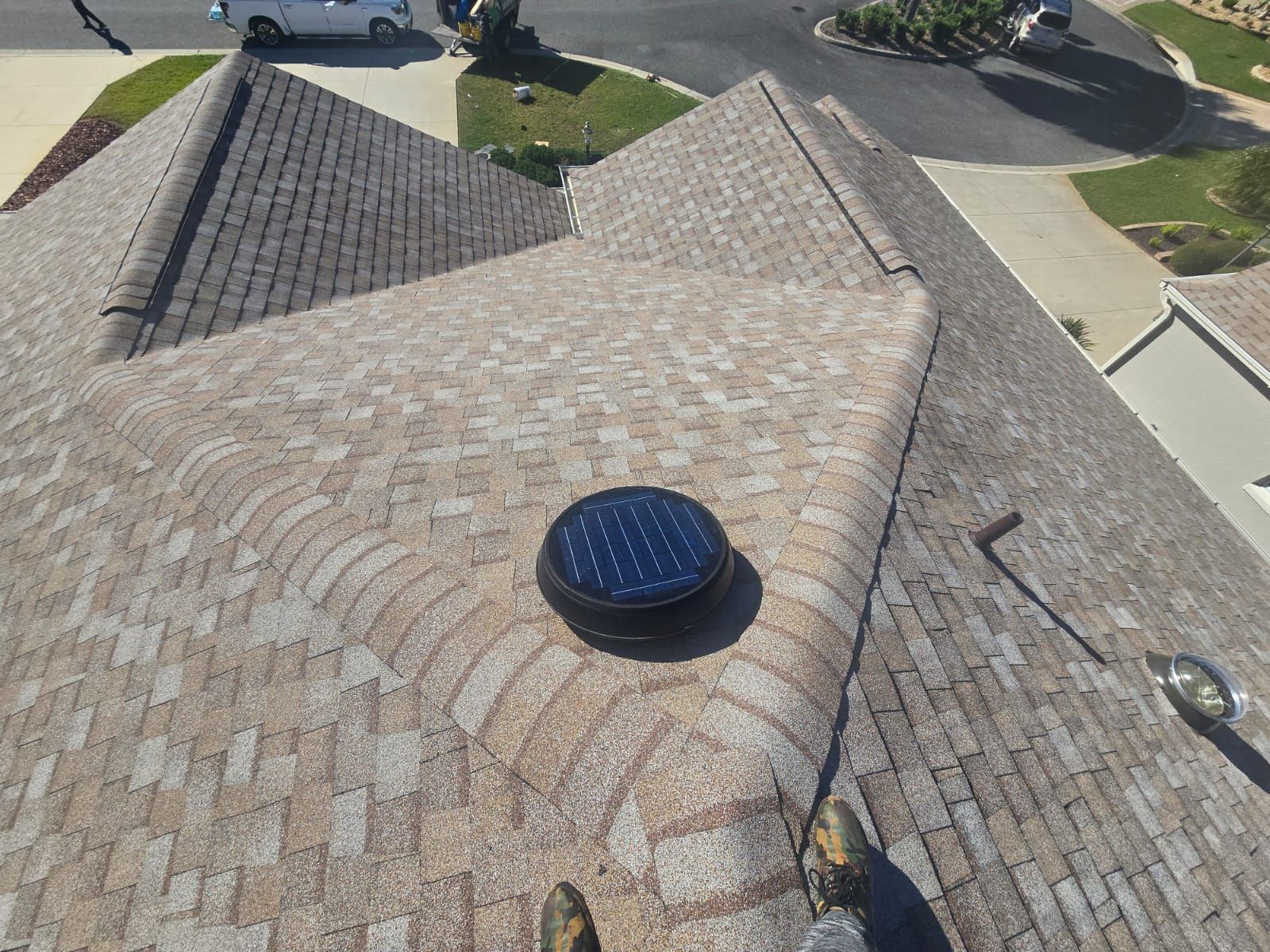 Logams Roofing crew installing impact-resistant asphalt shingles on a Kissimmee, Florida home, providing reliable 70 mph wind resistance and algae protection.