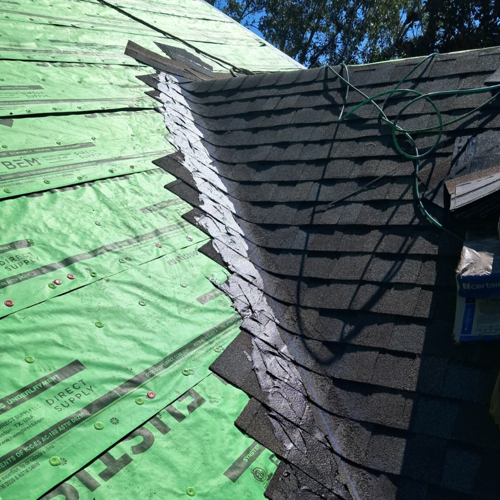 Shingle roof replacement in Florida with synthetic underlayment installation — preparing damaged roof deck for new asphalt shingles.