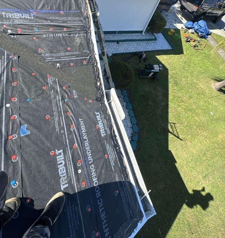Shingle roof replacement in progress in Orlando FL — underlayment installation ensuring waterproof protection for residential homes.