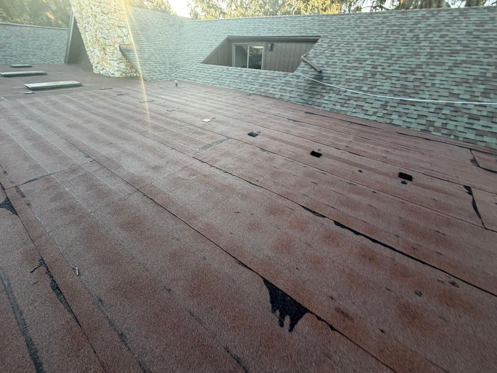 Roof underlayment phase during shingle installation in Casselberry Florida showing secure nailing and waterproof membrane application.