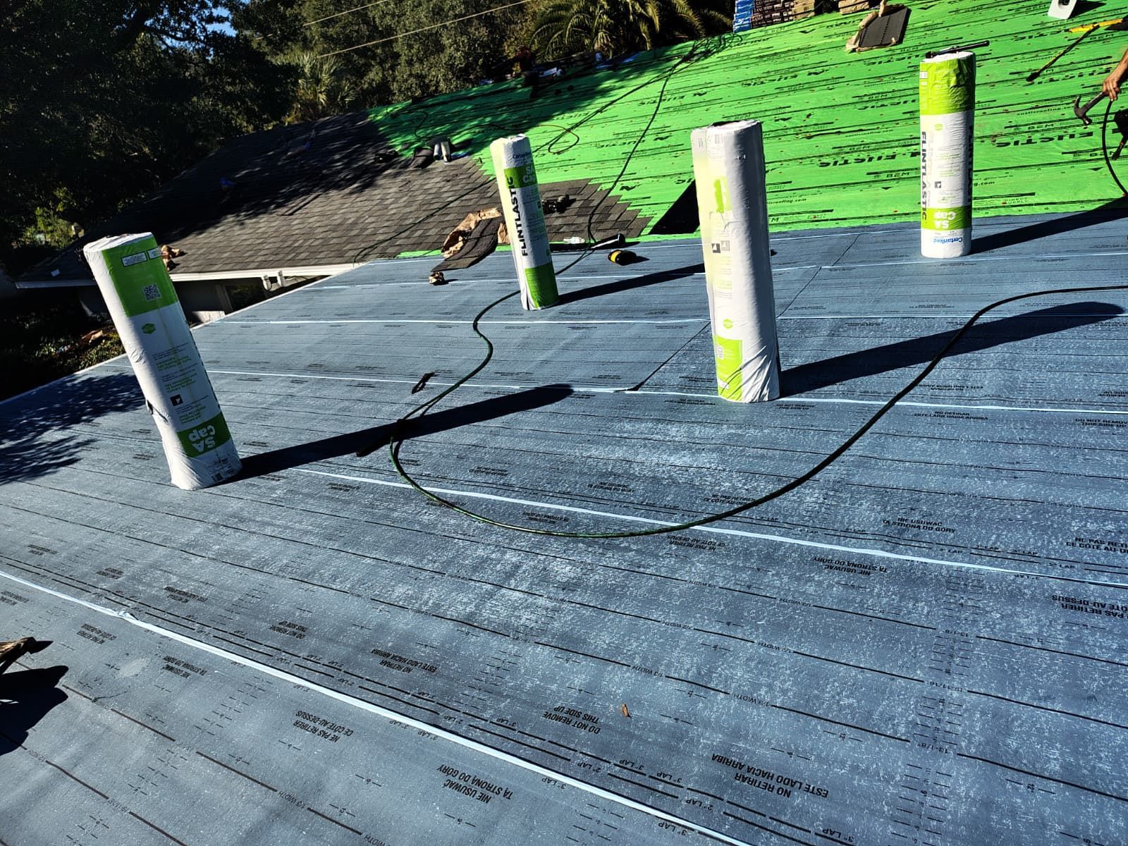 Logams Roofing project manager reviewing Lake County building plans for a roof installation in Mount Dora, ensuring full compliance with local hurricane and lakefront construction codes.