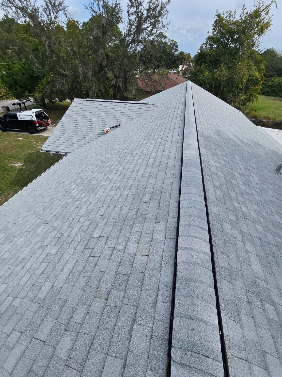 Newly installed asphalt shingle roof in Florida at sunrise, showing clean roof lines and proper ventilation installed by residential roofing contractors in Orlando.