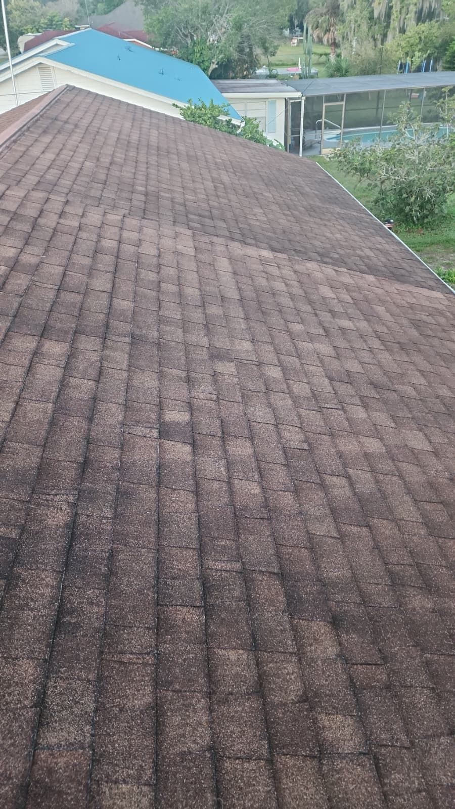 Old asphalt shingle roof in need of replacement on a Florida home, showing visible wear before roof restoration.
