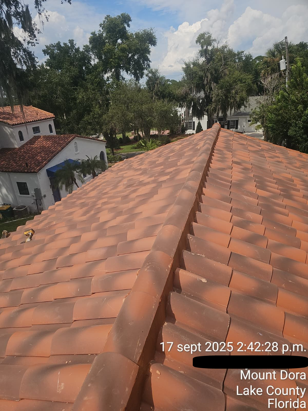 Clay tile roofing on Orlando home reflecting sunset — durable roof material after professional restoration.