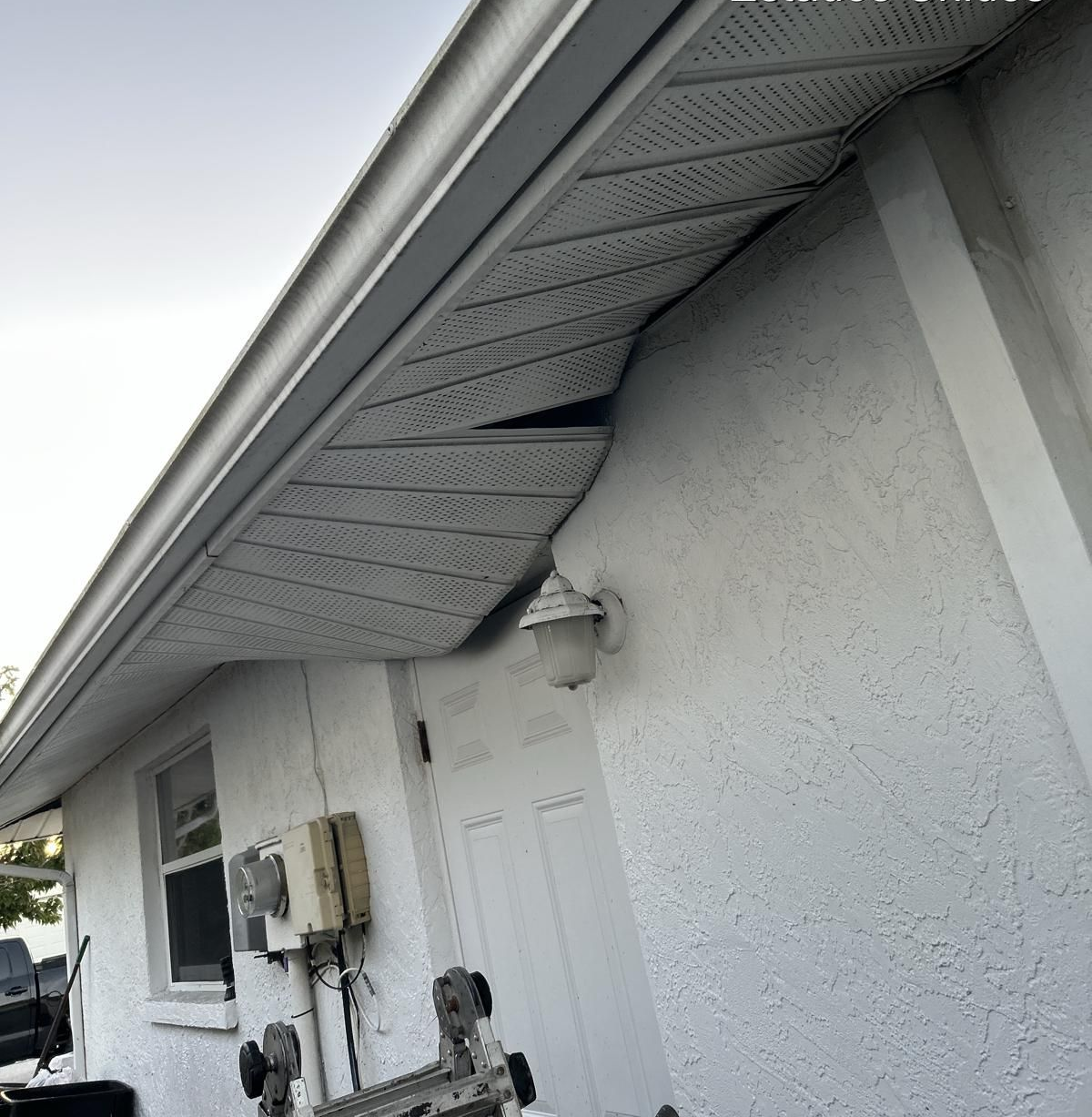 Damaged soffit and fascia on residential roof in Florida — example of wear before professional shingle roofing repair.