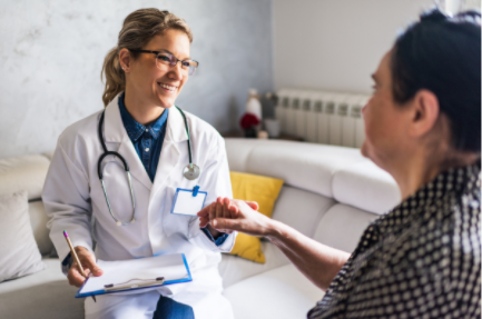 A woman wearing glasses and a white shirt is sitting on the floor.