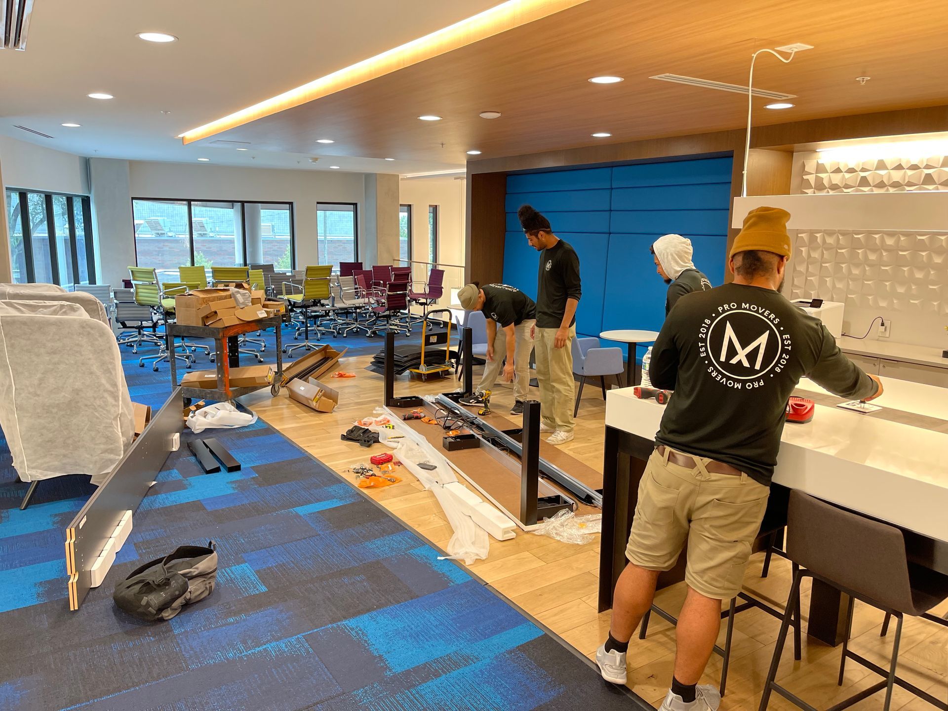 A group of men are working in a large room.