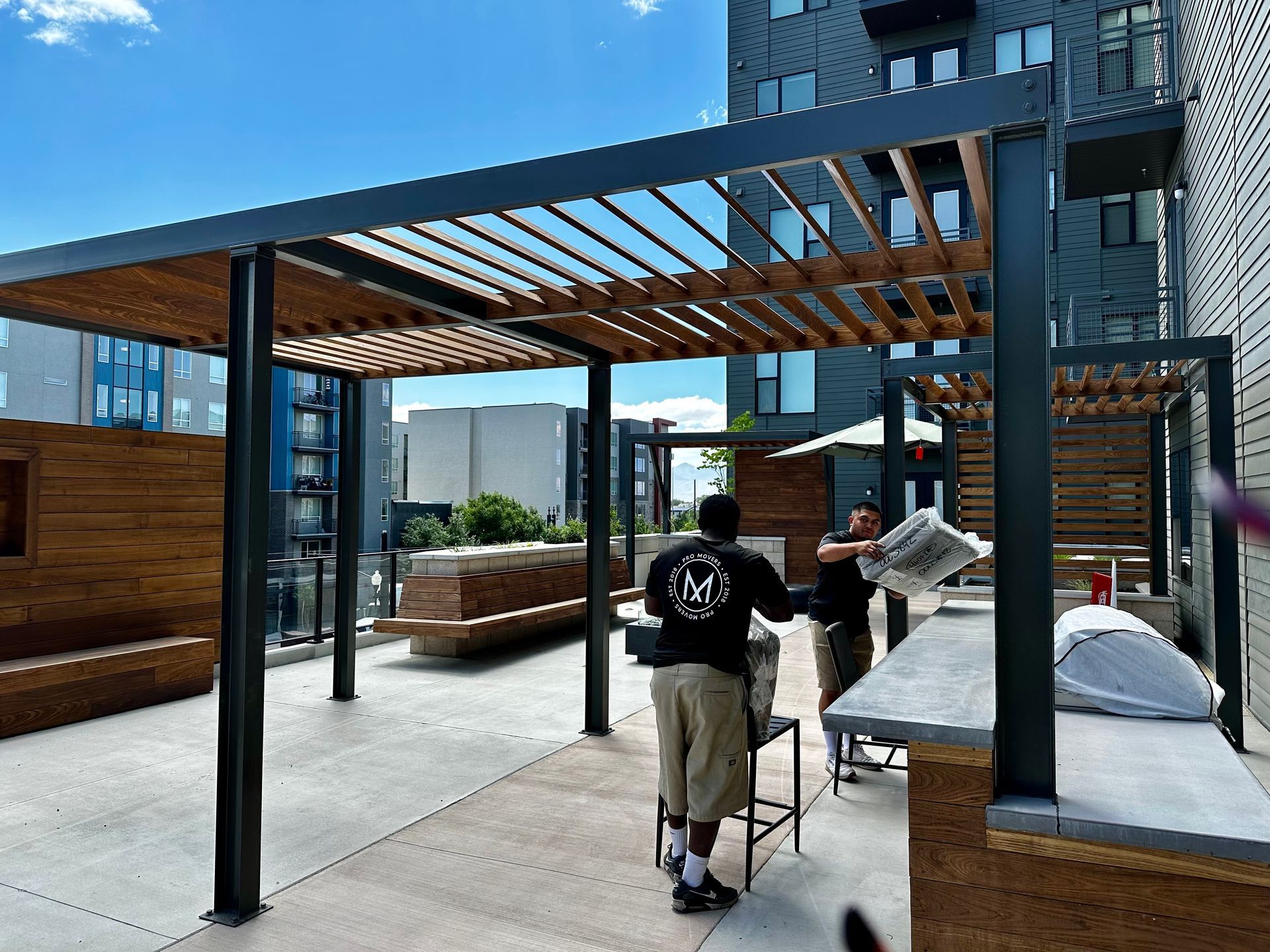 A man wearing a black shirt with the letter m on it