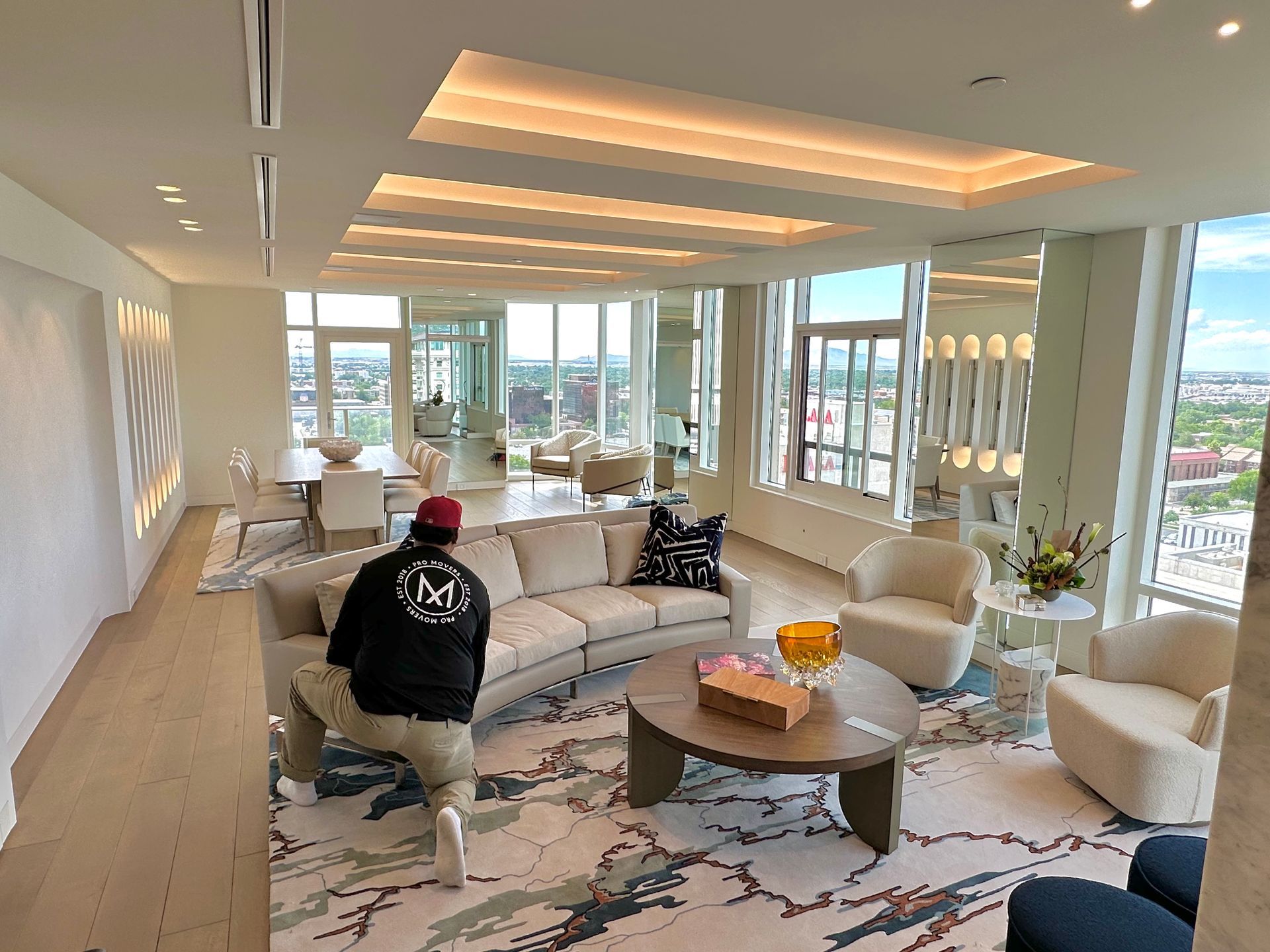 A man is sitting on a couch in a living room.