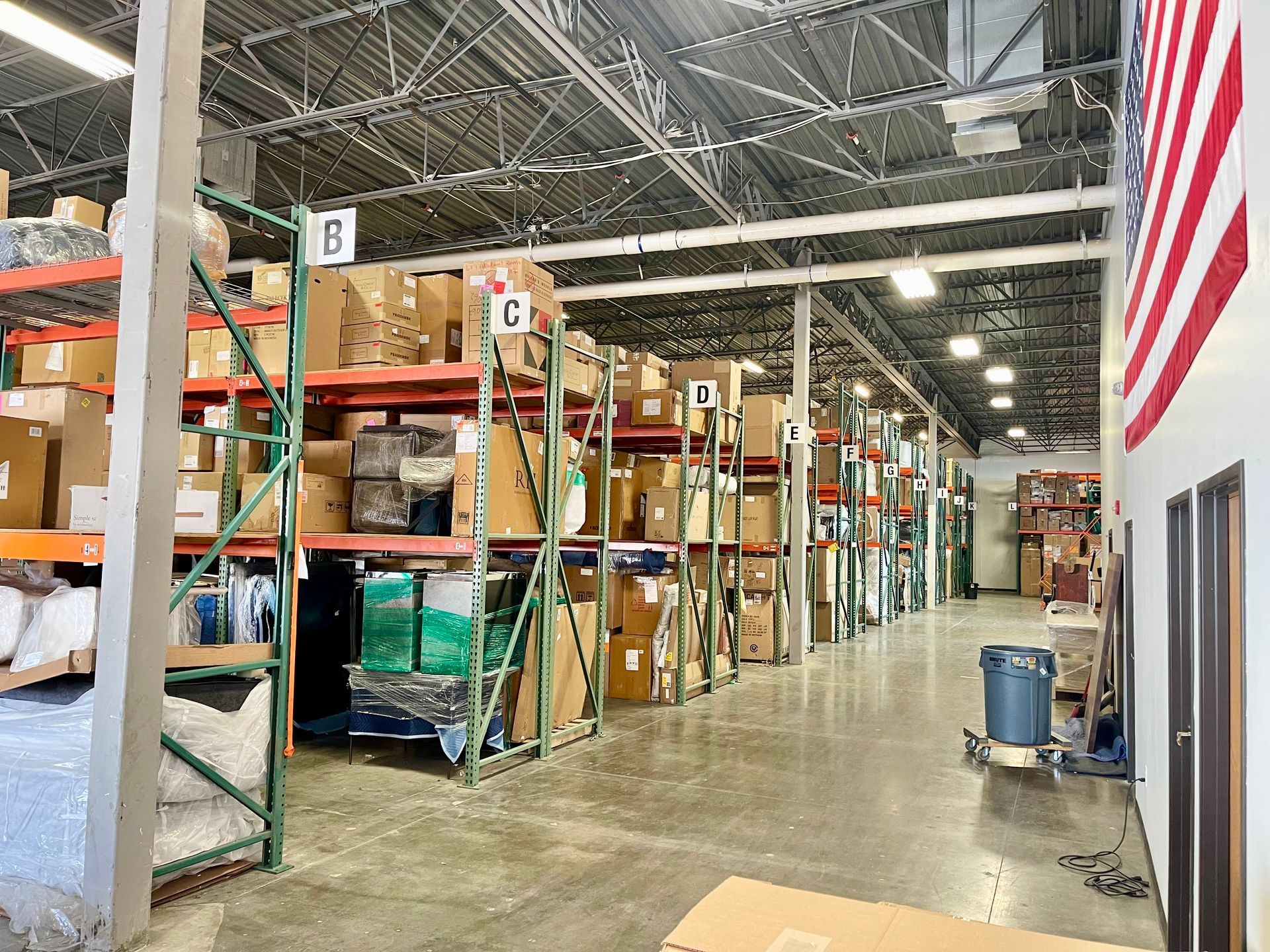 A large warehouse filled with lots of boxes and shelves.