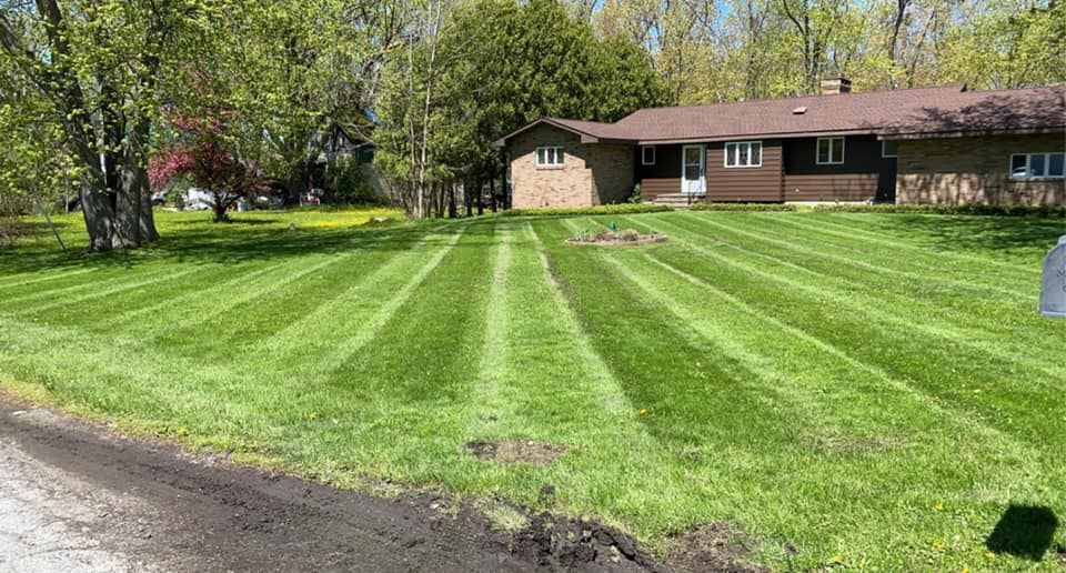 A house with a lush green lawn in front of it.