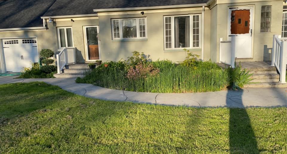 A house with a shadow of a person on the sidewalk in front of it