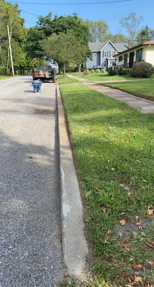 A car is parked on the side of the road next to a curb.