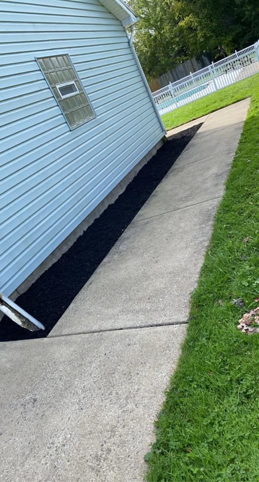 A sidewalk next to a house with a hole in the ground.