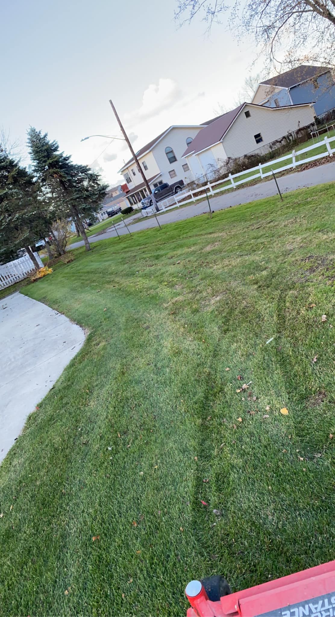A lawn mower is sitting in the middle of a lush green field.
