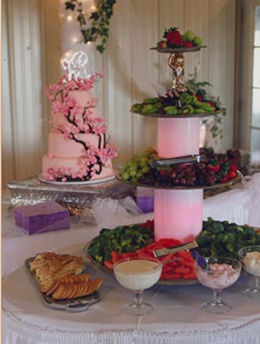 A table set for a wedding reception with a candle on it.