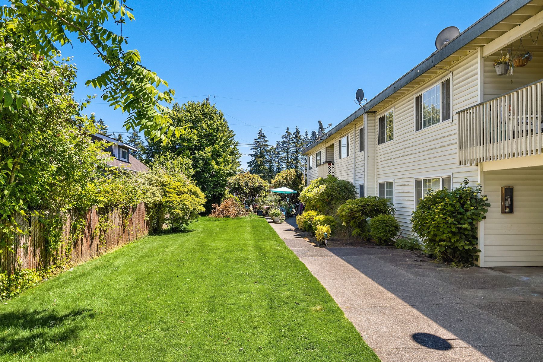 esquire exterior with lawn side view and walkway with trees
