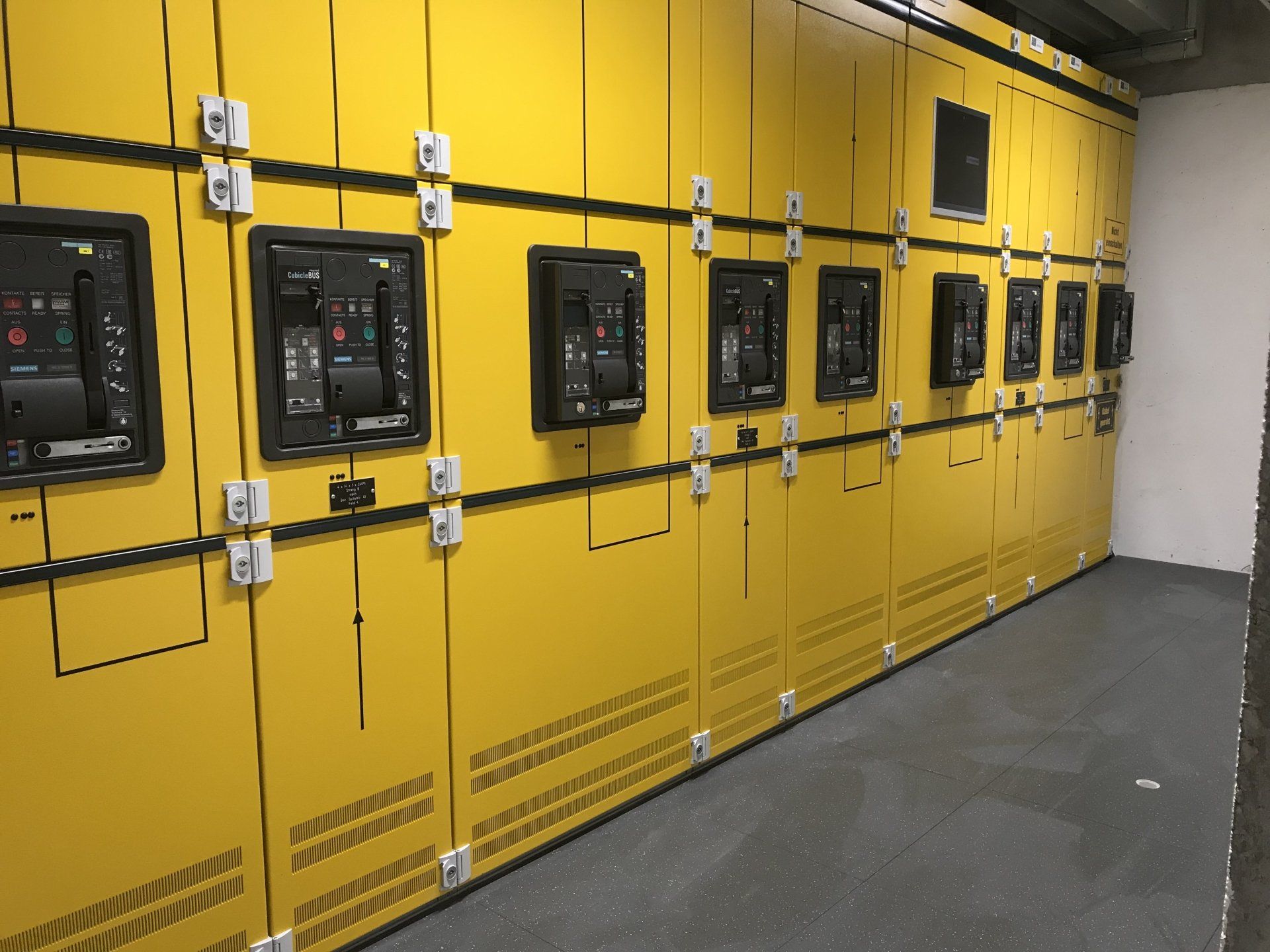 A row of yellow electrical panels in a room