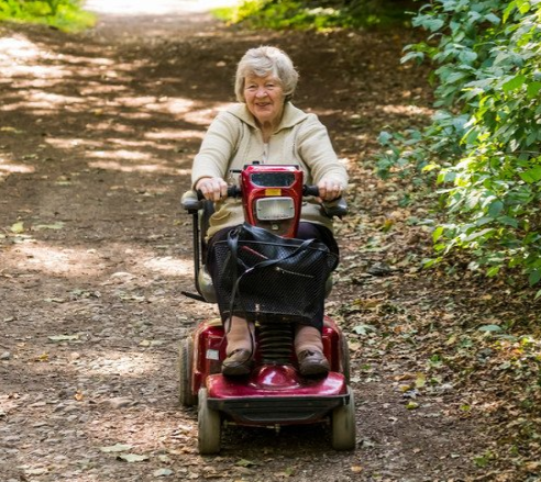 senior woman using a walker cross street