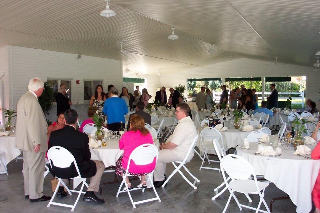 A group of people are sitting at tables in a large room