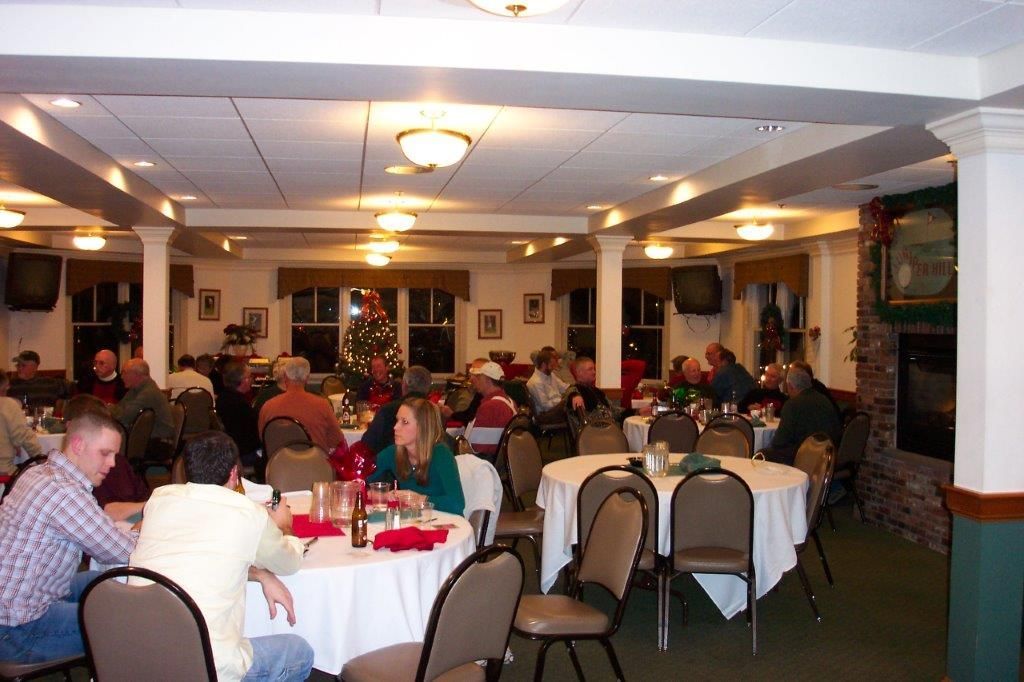 A group of people are sitting at tables in a large room