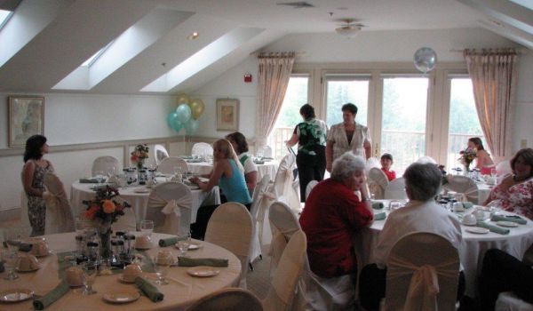 A group of people are sitting at tables in a room