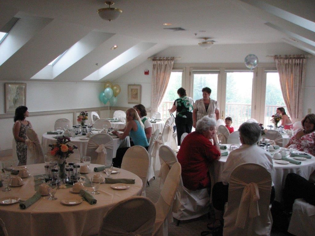 A group of people are sitting at tables in a large room