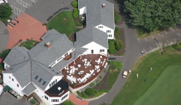 An aerial view of a large house with a large deck