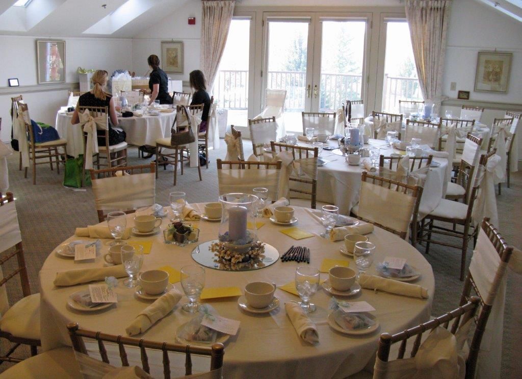A large room with tables and chairs set up for a party