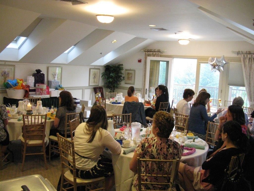 A group of people are sitting at tables in a room.