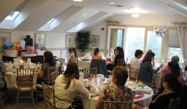 A group of people are sitting at tables in a room