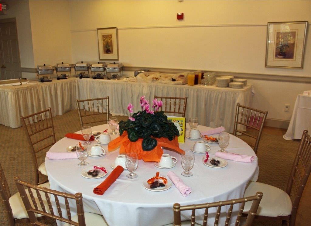 A round table with a vase of flowers on it