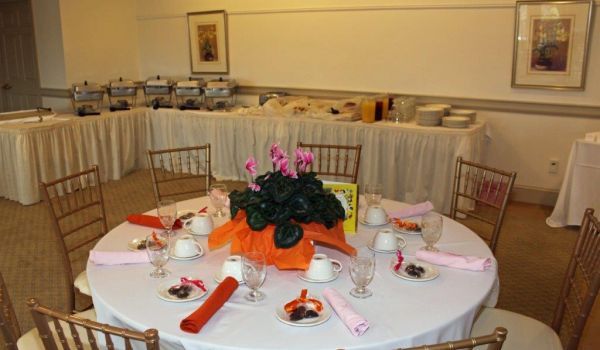 A round table with a vase of flowers on it