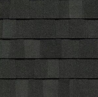 Close-up of dark gray asphalt roofing shingles arranged in overlapping rows.