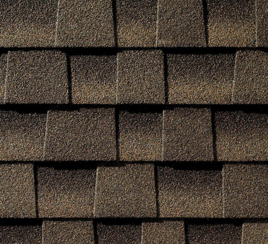 Close-up of overlapping brown asphalt roof shingles.