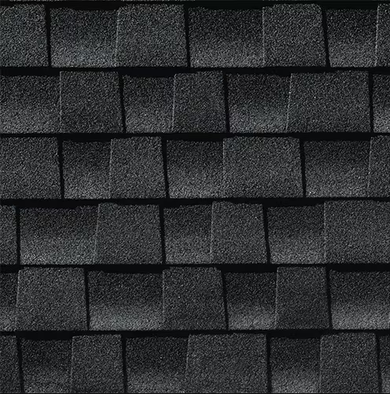 Close-up of a dark gray asphalt shingle roof. The shingles have a textured surface, and are arranged in staggered rows.