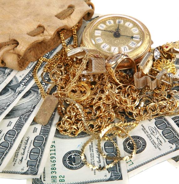 A pile of money with a watch on top of it