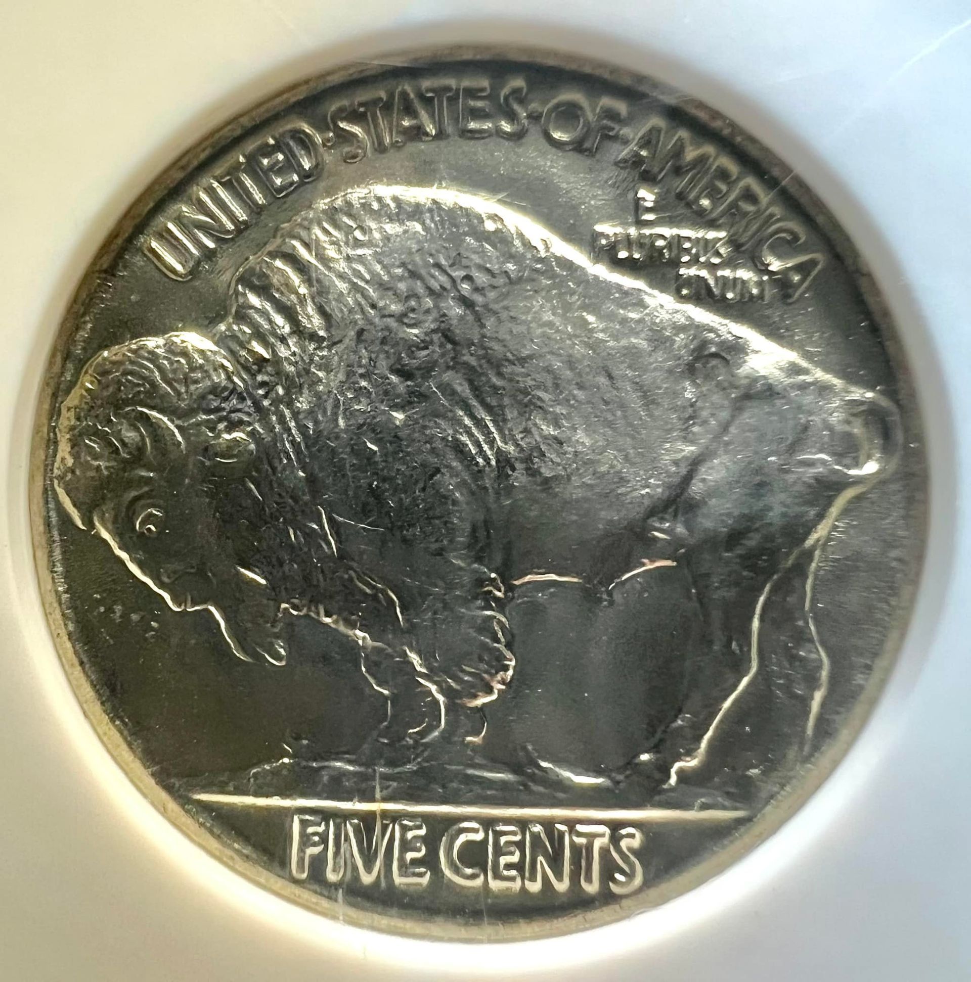 Silver coins and bars displayed in black trays.