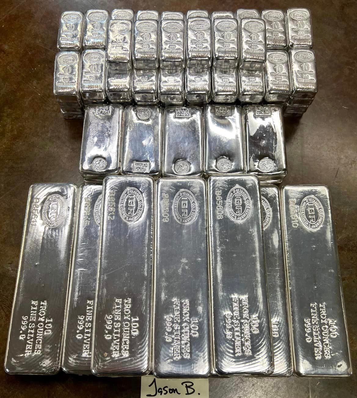 A bunch of silver bars are stacked on top of each other
