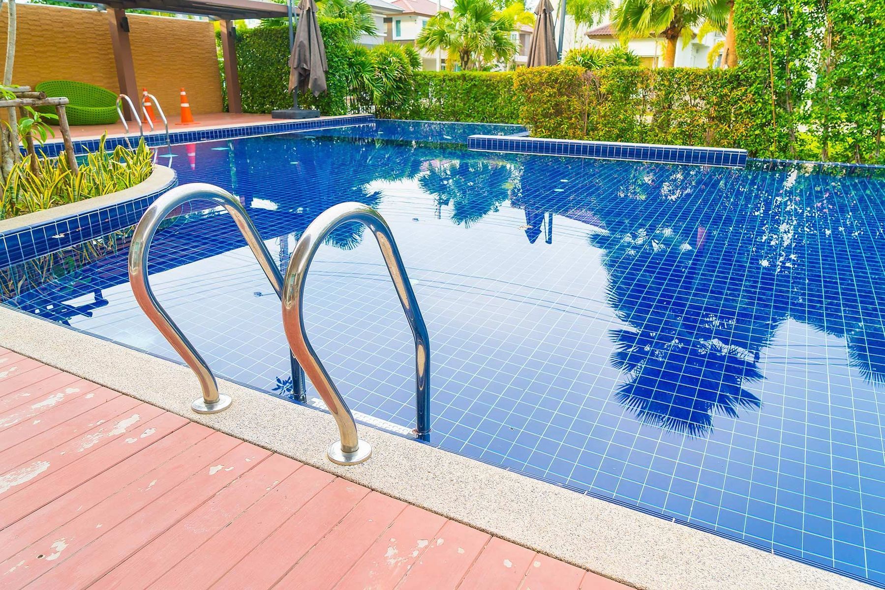 A large swimming pool with stairs leading to it.