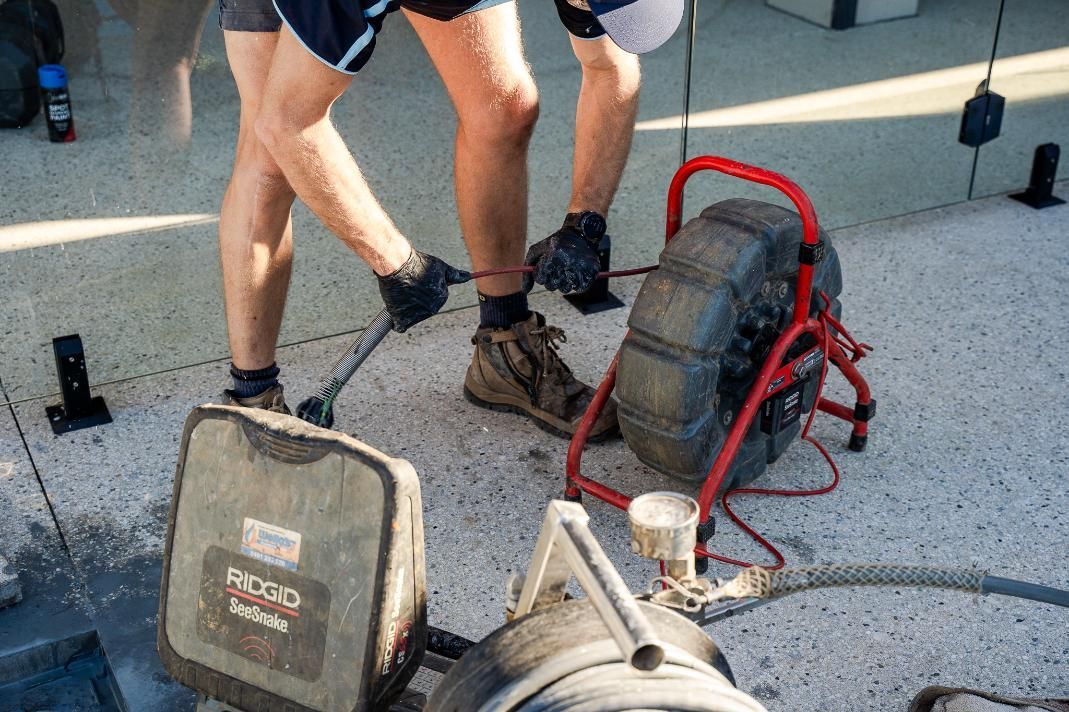 Two Men Are Working on a Drain With a Camera — Wello's Plumbing & Gas In Thurgoona, NSW
