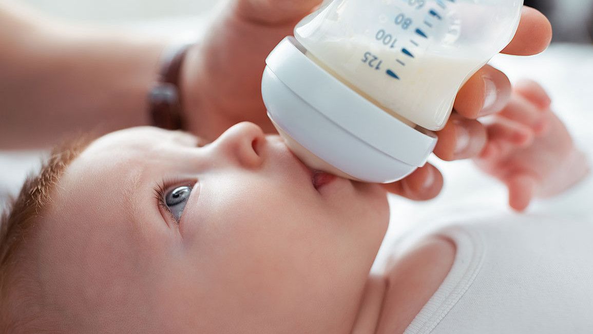 Ein Baby trinkt Milch aus einer Flasche.